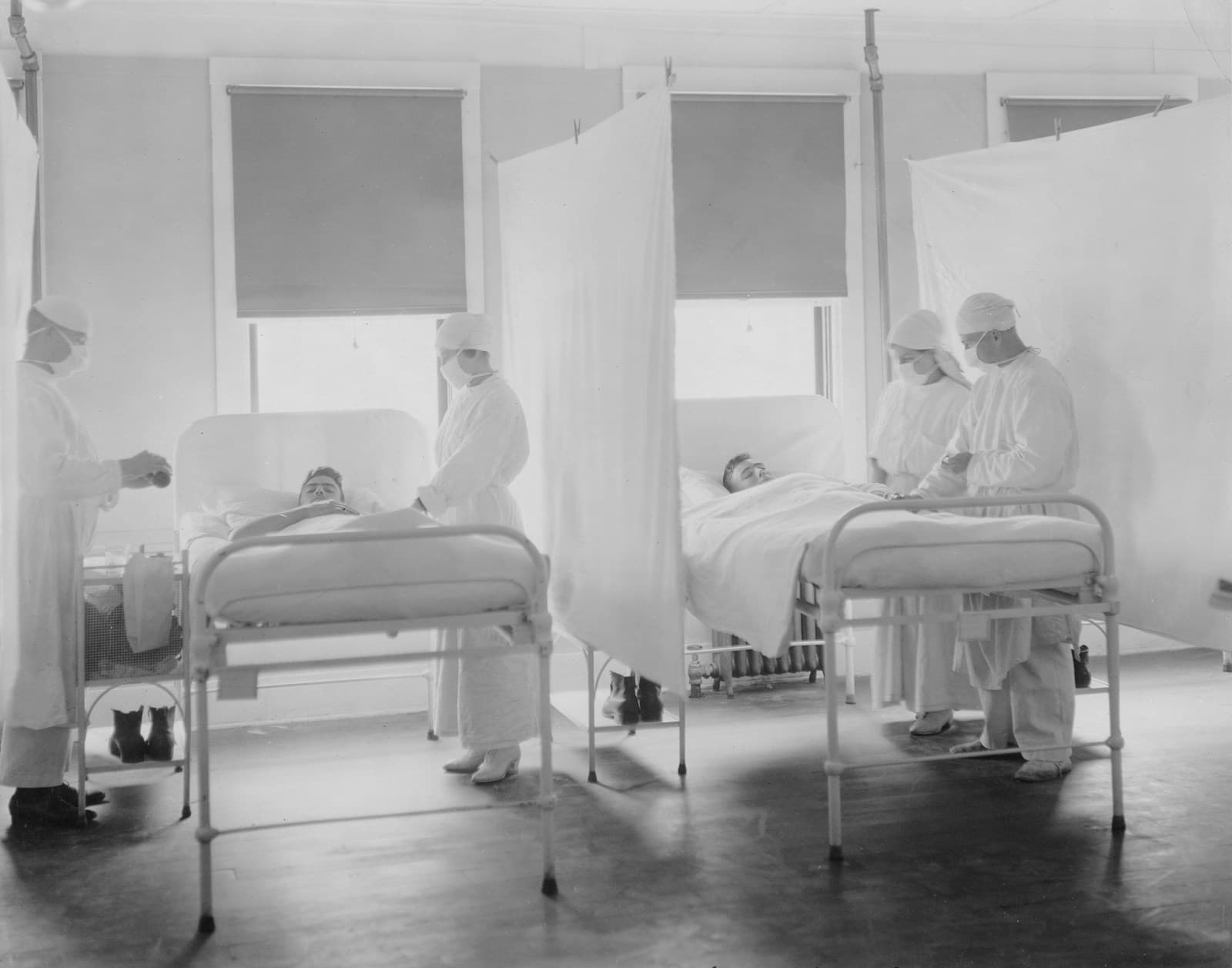 Medical staff attending patients in a hospital ward during the 1918 influenza epidemic
